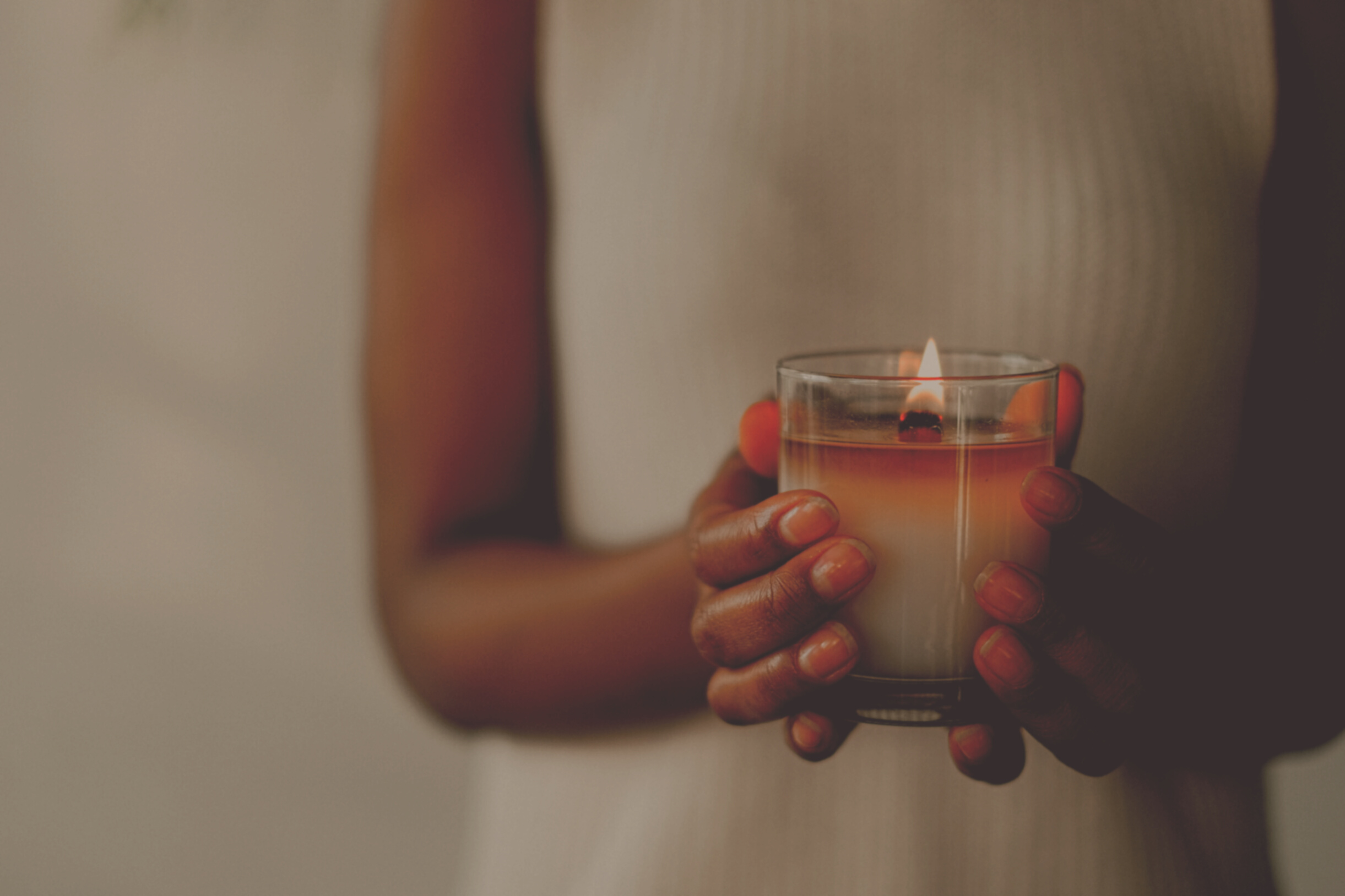 Crop black woman with burning candle